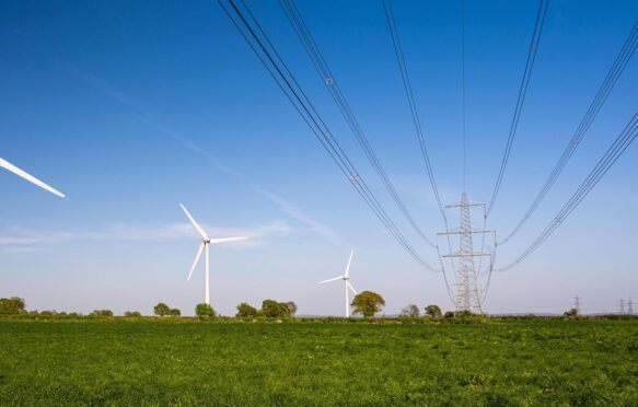 风力涡轮机在国家电网高压输电线在格洛斯特郡。
