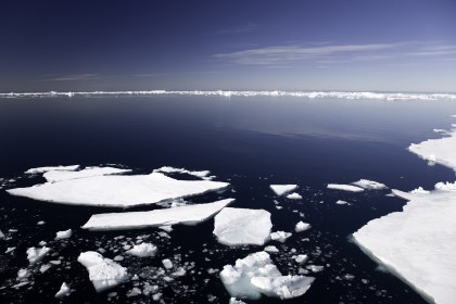 冰床在南极洲，冰山在背景中，深蓝色晴朗的天空
