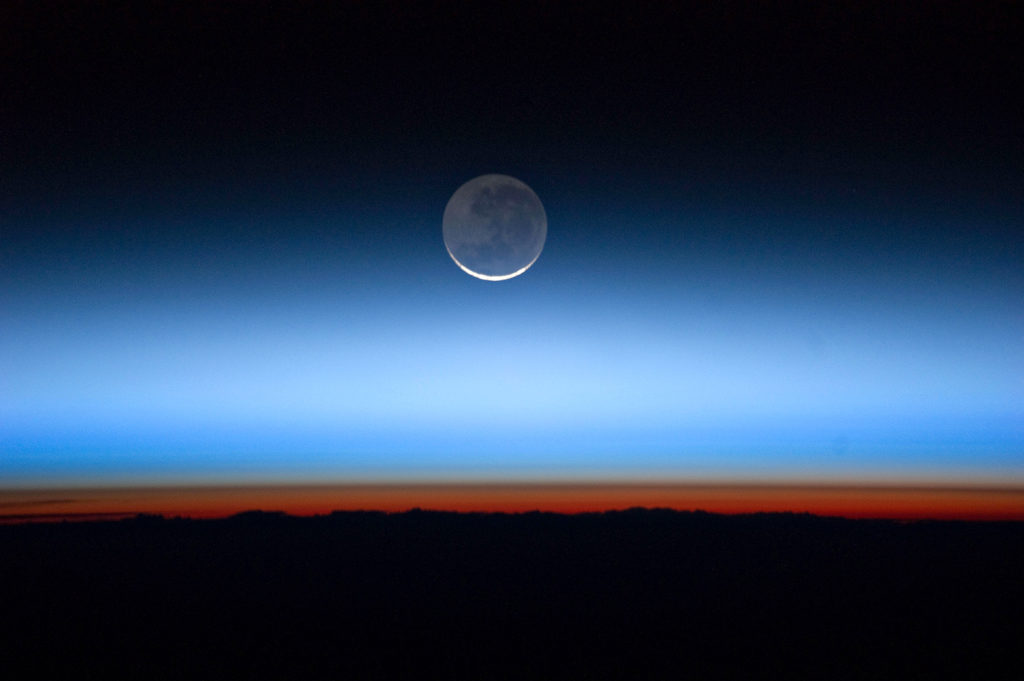 月亮与橙色的对流层乐队,最低和最密集的部分地球大气层。对流层顶的对流层突然结束,出现在形象之间的尖锐边界橙色,蓝色,彩色的气氛。来源:美国国家航空航天局照片除股票的照片。D7KRFX