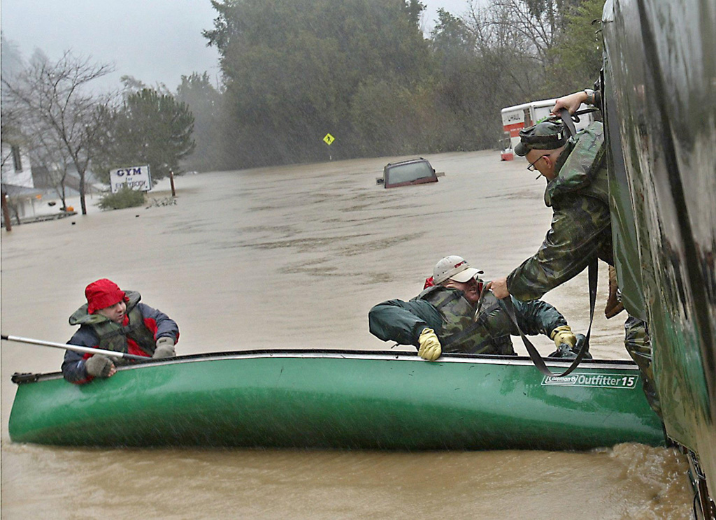 Two-men-are-rescued-by-the-National-Guard-after-their-canoe-tips-over-in-the-flooded-streets-of-Guernville-California