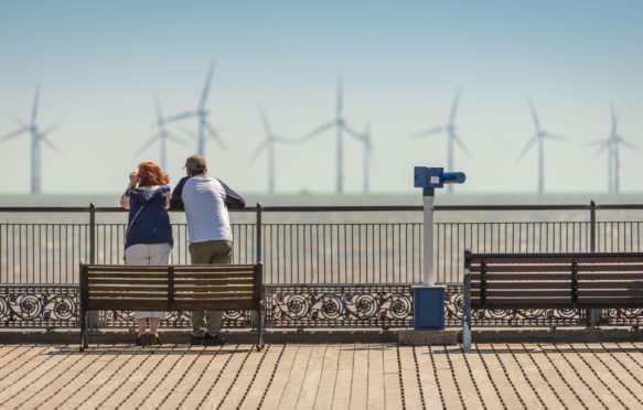 Tourists-enjoying-the-hot-weather-on-Skegness-Pier-and-viewing-the-offshore-wind-farms