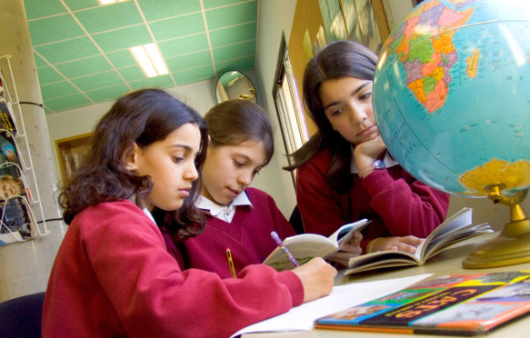 三个初中女孩学习世界地理研究阿特拉斯学校library_A0NP28
