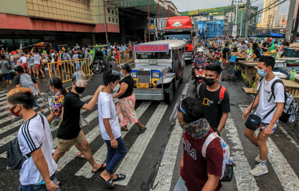 戴着防护面具的人在马尼拉的一个繁忙的街道,2021年3月